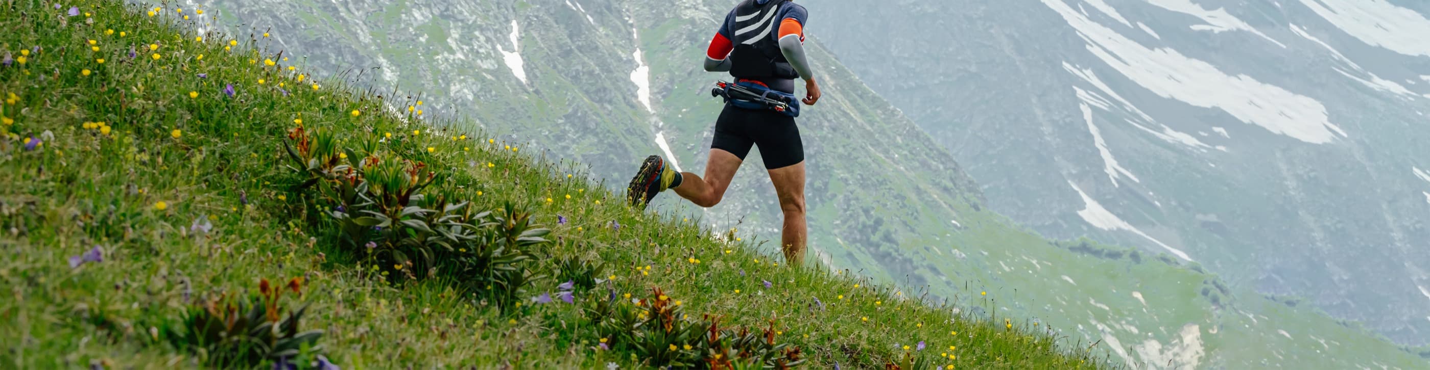 A runner on a mountain ridge during a skyrunning race